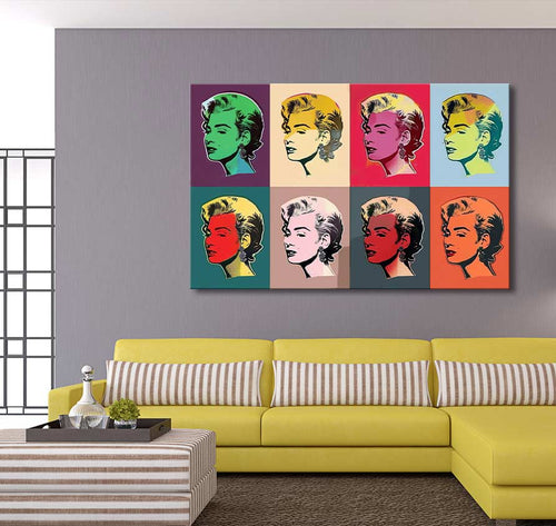 Andy Warhol signature - Marylin Monroe 8 pop art canvas, featuring eight vibrant panels, adorns a modern living room with a yellow sectional and striped ottoman.