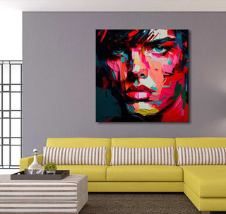Françoise Nielly-signature painting Dave by Night, showcases an expressive male face in bold colors, enhancing a modern living room with a yellow sofa.