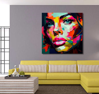 Françoise Nielly-signature - Gaby by Night: A bold pop-art portrait of a woman’s face, vibrant and expressive, hangs above a modern yellow sofa in a contemporary living room.
