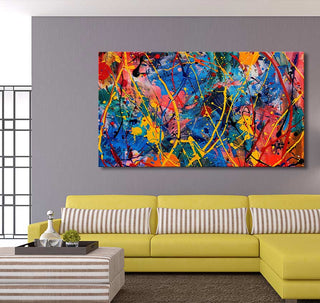 Jackson Pollock signature - Candy Shop: vibrant, abstract splatter-paint canvas with bold colors, ideal for modern interiors, displayed above a yellow L-shaped sofa.