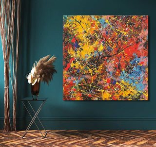 Jackson Pollock-style abstract painting Spring has Sprung, vibrant drip art on canvas, displayed in a stylish interior with minimalist decor against a teal-green wall.