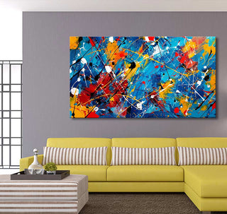Jackson Pollock signature painting Tropical Island featured in a contemporary living room, highlighting its vibrant abstract style with a yellow sofa and striped accents.