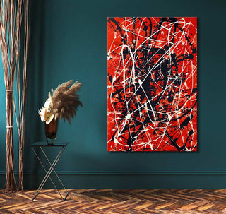 Jackson Pollock signature – Dreams on Red: Abstract oil painting with vibrant splatters, on teal wall above a black side table, accented by a vase of dried botanicals.