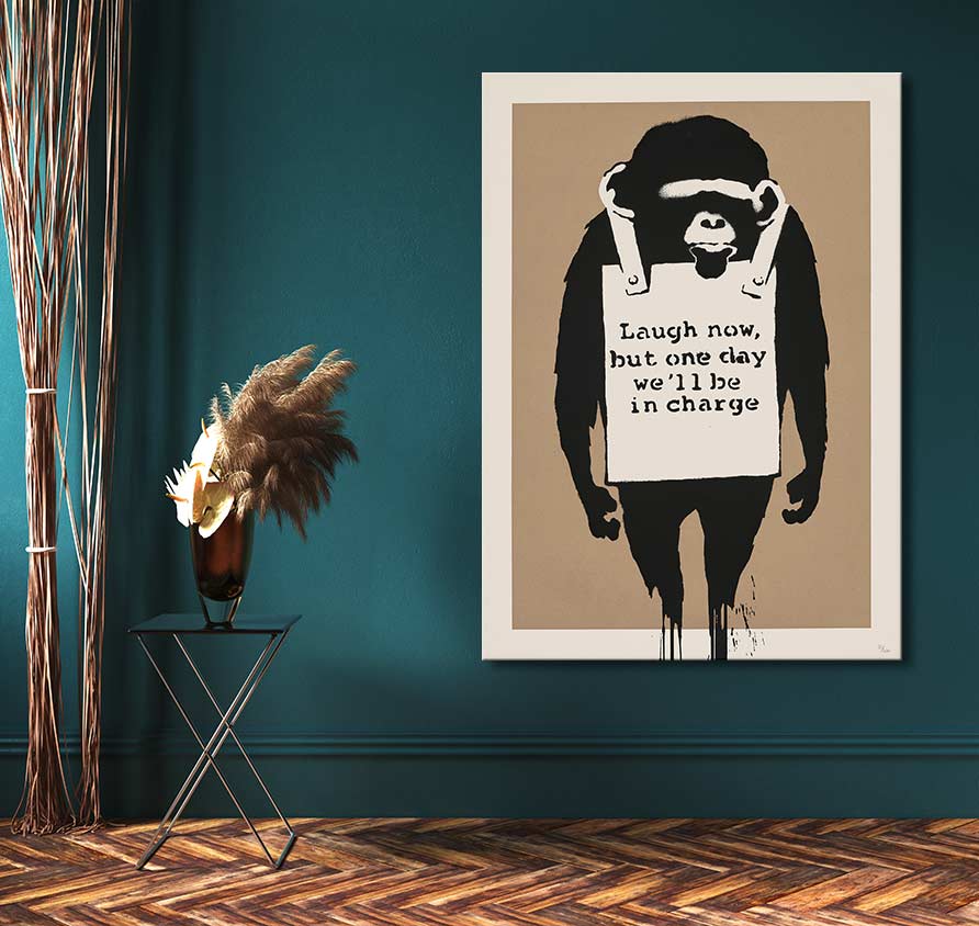 Banksy - Darwin was Right: Stencil-style chimpanzee print with graffiti art, displayed in a room with a side table and dried pampas grass.