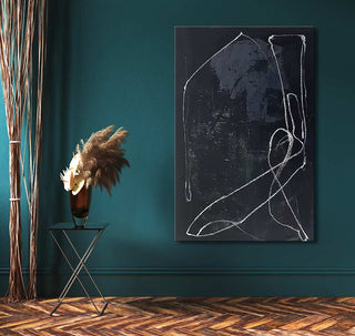 Julian-Mereuta's Home painting, featuring abstract black and white loops, hangs on a teal wall, complemented by a metal table with a copper vase.