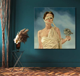 Surreal painting Vleugellam by Ans Marcus, showing a blindfolded woman with a bird, draped in ivory fabric. Ideal for modern art enthusiasts.