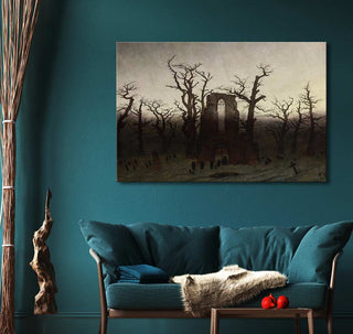 Caspar David Friedrich's Abtei im Eichwald oil painting, depicting a Gothic chapel amid bare trees, enhances a teal-themed living room with its moody, romantic style.