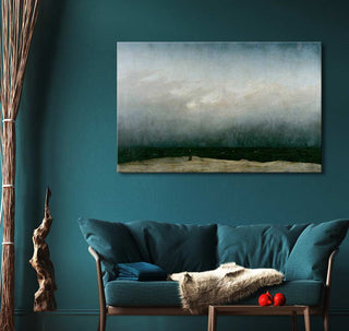 Caspar David Friedrich's Der Mönch am Meer oil painting displayed above a teal couch, capturing a lone figure on a beach, adding depth to the modern sitting area.