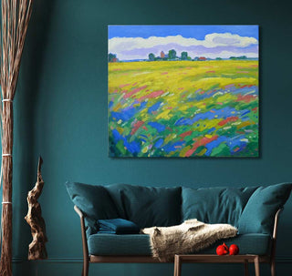 Oil painting Korenvelden bij Finkum by Dirk Beintema, showcasing wildflowers and farm buildings, displayed above a teal loveseat in a contemporary living room setting.