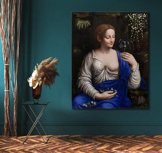 Francesco Melzi's Flora painting, depicting a woman holding blossoms, elegantly styled in a room with contemporary decor including a bronze vase with pampas grass.