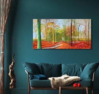 David Hockney's Woldgate Woods painting features an autumnal tree-lined path, displayed above a teal loveseat with decor elements like a driftwood sculpture.