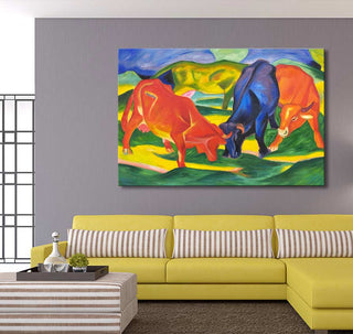 Franz Marc's Fighting Cows oil painting, featuring three stylized cows on a vibrant canvas, complements a modern living room with a yellow sofa and striped ottoman.