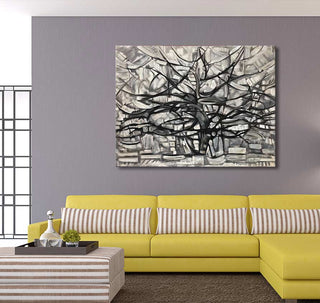 Piet Mondriaan's 'Girgio Tree' painting, abstract branches on canvas, adorns a modern living room with a yellow sectional and striped ottoman.