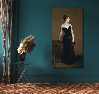 John Singer Sargent’s Madame Pierre Gautreau portrait in a black gown, displayed against teal wall with pampas grass arrangement on metal table.