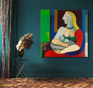 Picasso signature - La Reve: A cubist painting of a mother nursing her baby on a teal wall, complemented by a black metal side table and pampas grass.