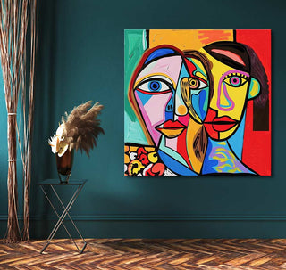 Cubist-style painting Twee Vrouwen by Picasso signature, featuring two abstract faces, displayed on a wall with a side table and pampas grass nearby.