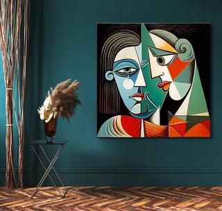 Picasso-inspired True Lovers 2 painting, showcasing abstract faces in cubist style. Set against a teal wall, complemented by black metal table with dried floral arrangements.