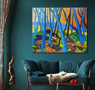 David Hockney's Winter Trees painting above a teal sofa in a modern living-room setting, showcasing a vivid forest scene in bold colors.