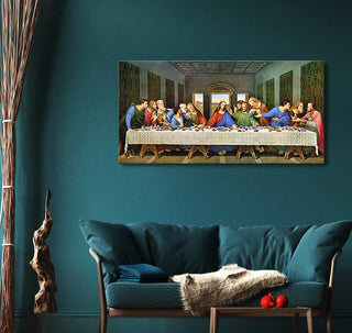 Leonardo da Vinci's The Last Supper reproduction, mounted above a teal loveseat with a decorative throw and cushion, set in a cozy living room display.