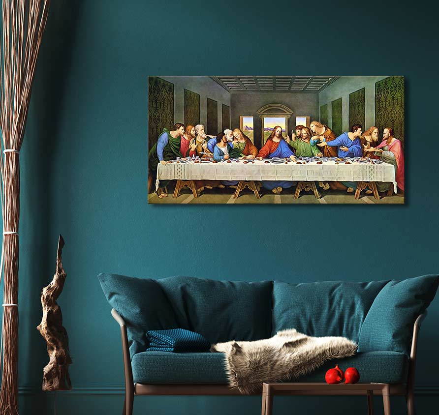 Leonardo da Vinci's The Last Supper reproduction, mounted above a teal loveseat with a decorative throw and cushion, set in a cozy living room display.