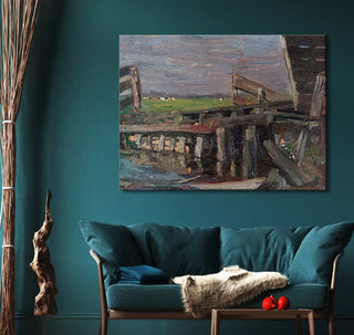 Piet Mondriaan's 'Oude Brug in Brabant' oil painting, showcasing a rustic wooden bridge, hangs above a teal loveseat in a cozy vignette.