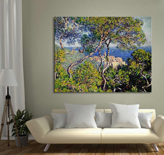 Claude Monet's Bordighera painting (80x63cm) displayed above a cream sofa, depicting Mediterranean landscape with pine trees and sea, ideal for elegant interiors.