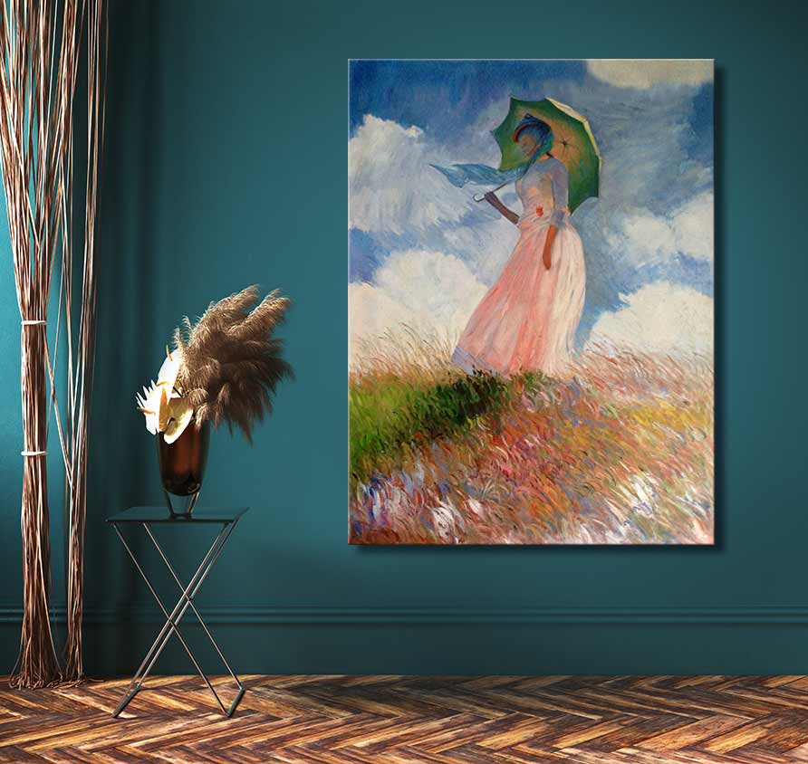 Handgeschilderd olieverfschilderij Dame met Parasol van Claude Monet, opgehangen tegen een teal-groene muur naast een zwart metalen bijzettafeltje met pampasgras.