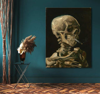 Vincent van Gogh - Kop van een Skelet met Brandende Sigaret, framed oil painting on dark teal wall, with side table and decor, ideal for modern interiors.